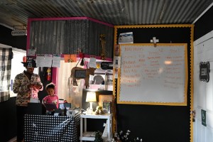 Quenten Thomas-White sits behind the counter of his restaurant, Big Daddy’z BBQ & Soul Food, with his daughter.